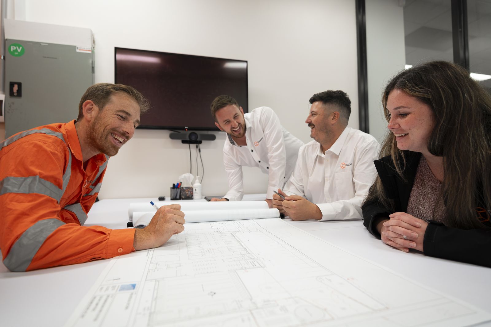 Ducon project team over drawings at Clayton South